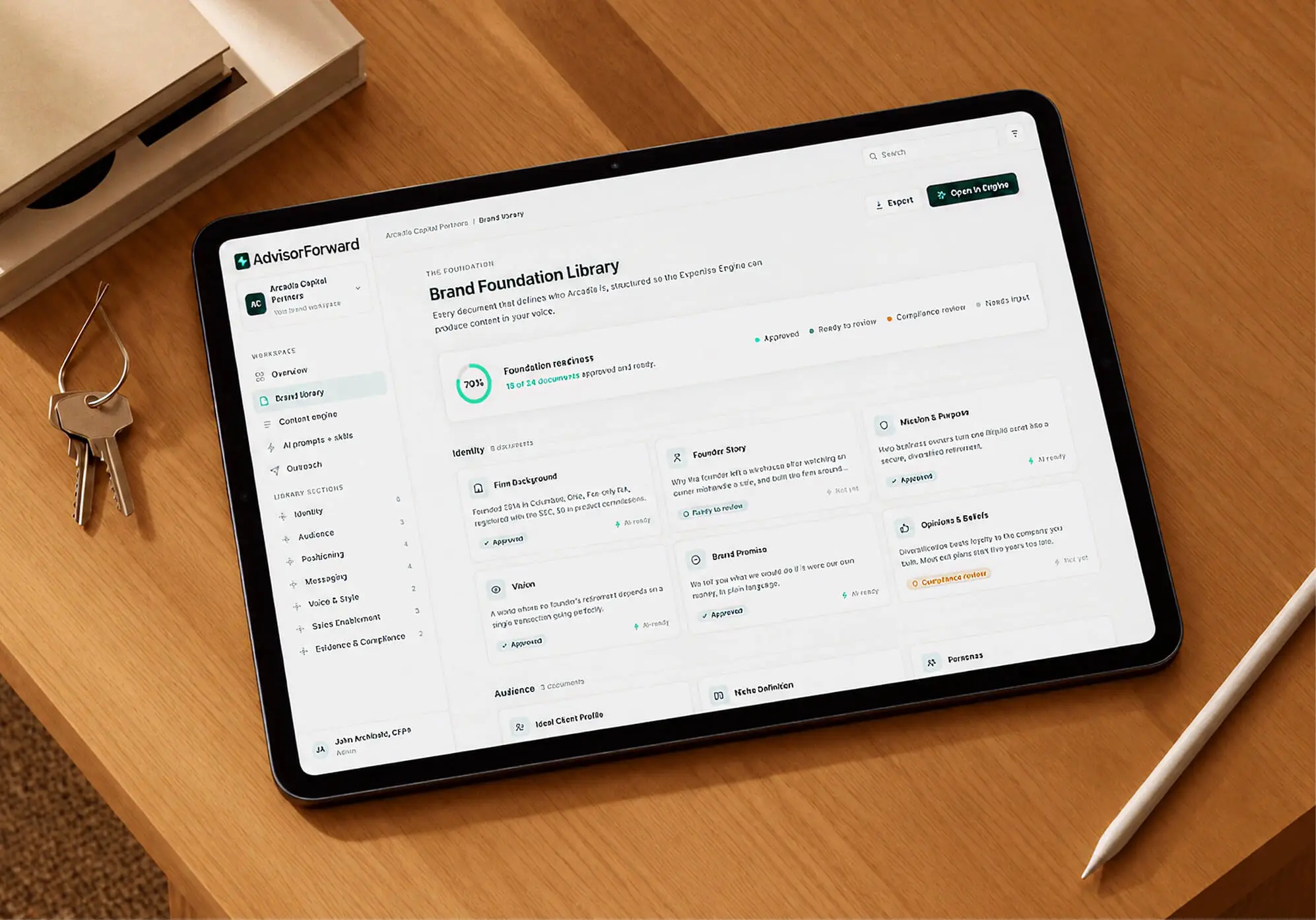 A tablet showing an AdvisorForward Brand Foundation Library dashboard, its documents organized by section with approval statuses.